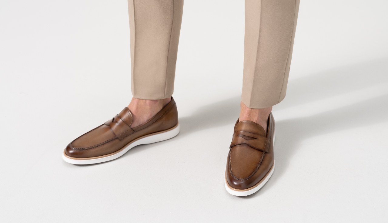 Close up of a model wearing beige pants and Magnanni Lalo loafers.