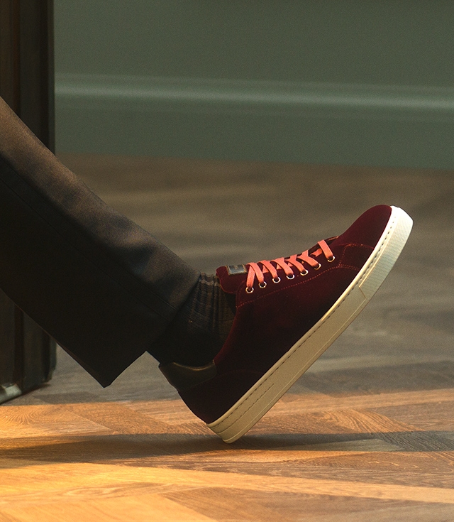 Close up of a male model in dark grey pants and Magnanni Berceo Burgundy sneakers.
