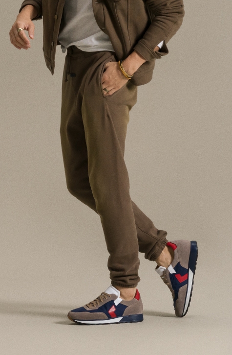 A male model in brown sweats sports the Magnanni Aero sneaker.