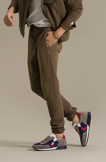 A male model in brown sweats sports the Magnanni Aero sneaker.