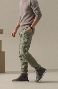A male model steps forward in green cargo pants and Magnanni Baker boots.